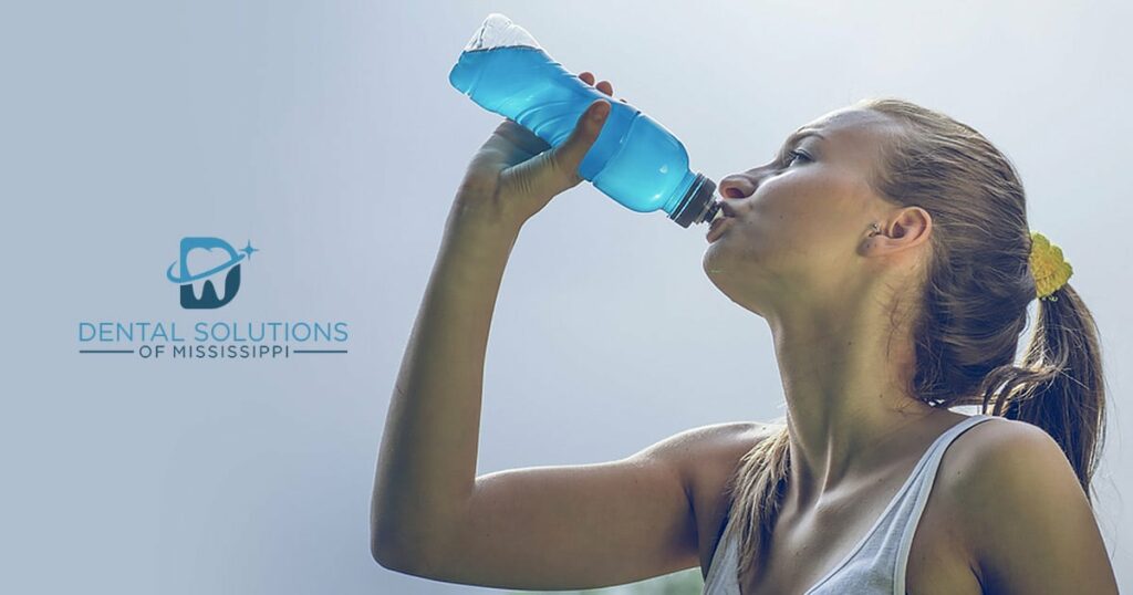 Woman drinking water Dental Solutions of Mississippi dentist in Canton MS Dr. Ruth Roach Morgan Dr. Jessica Morgan