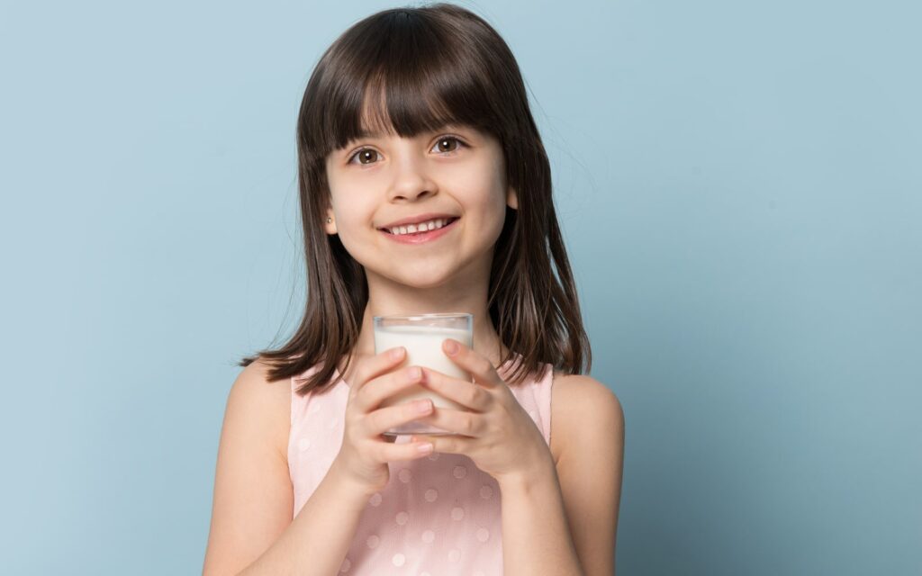periodontal disease The Fascinating Way Vitamin D Protects Your Gums Smiling child holding glass of milk Dental Solutions of Mississippi dentist in Canton MS Dr. Ruth Roach Morgan Dr. Jessica Morgan