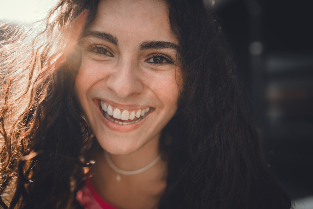 a girl happy to have a Functional, natural-looking results with restorative dentistry